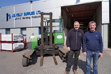 Left to right: operator Tony McManus and managing director Paul Kelly with the Combilift C-Series in front of the premises of J. G. Kelly Supplies Ltd.