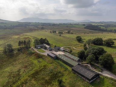 Aerial photograph of the Grade II Listed farm house and the surrounding countryside.