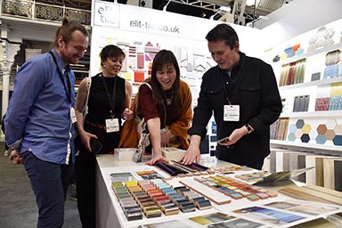 A group of people examining samples at an exhibition.