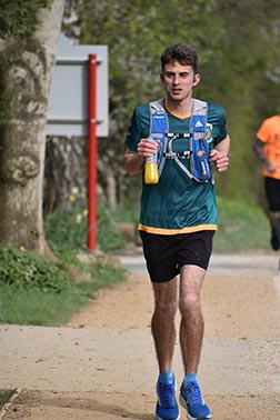 Eddy Webb running with a drink in his hand.
